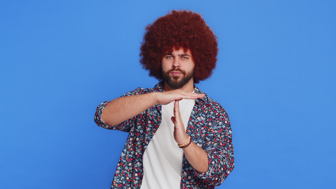 Tired upset stylish man showing pause gesture limit or stop sign time out take a break relax rest