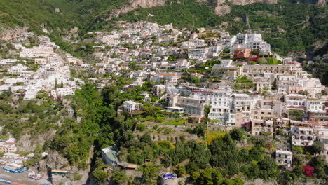 Flying-towards-Positano-in-Amalfi-coast,-Italy-during-a-sunny-day