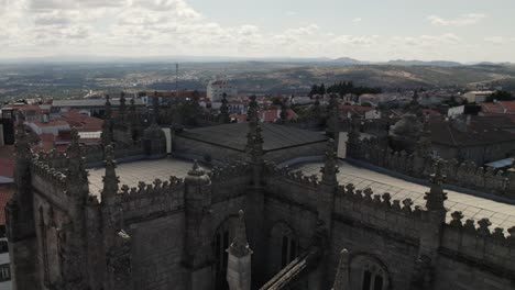 Flying-around-majestic-gothic-spires-of-the-Guarda-cathedral,-Portugal