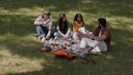 diverse group of friends enjoying a picnic in the park