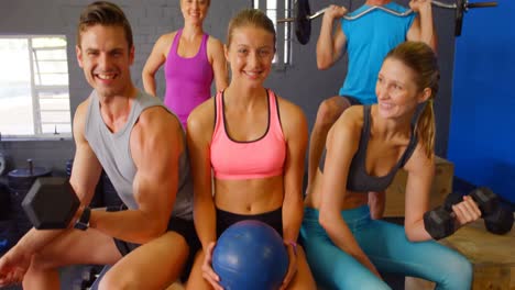 group of people sitting with fitness equipment