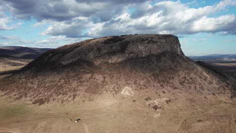 Aerial,-low-angle-shot-of-a-cliff-standing-out-in-the-Romanian-landscape