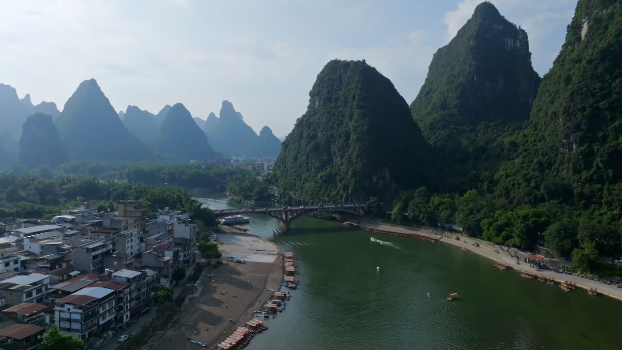 Drone flying along the Li river, toward the Yangshuo bridge, summer in China