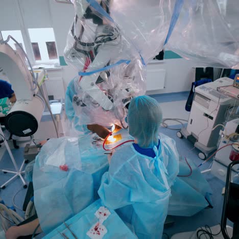 surgery process in modern operating room. medical workers use contemporary equipment during operation to a patient in clinic. top view.
