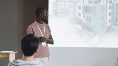 black architect presenting project on business conference