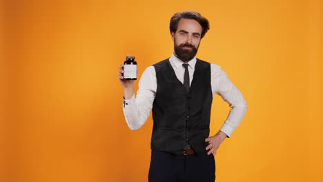 staff displays bottle of vitamins