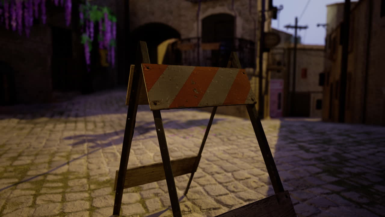 Construction barrier in quaint cobblestone street during evening hours