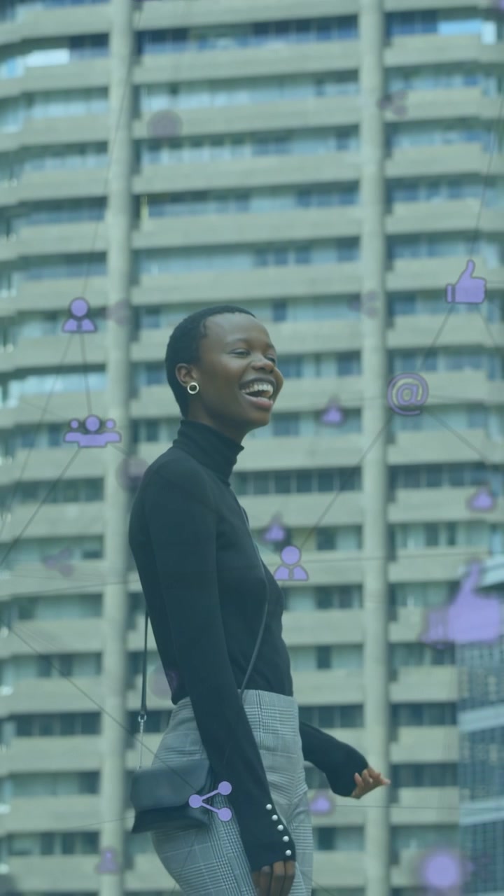 Vertical video: Woman smiling and walking, sparking purple social icons over her and tower for ads