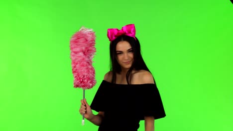 young beautiful woman wearing pink bow posing with a duster