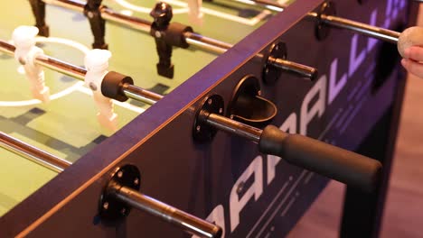 players engage in a fast-paced foosball match