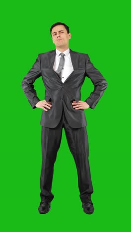 a man in a suit standing on a green screen in various poses