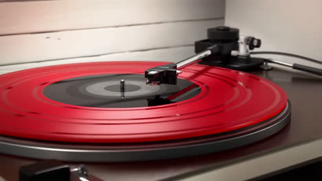 red vinyl record spinning on a turntable