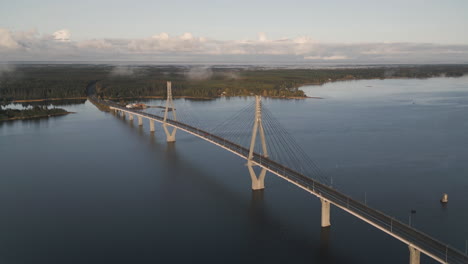 drone over replot bridge connecting islands in finland, following car traffic on scenic road above water, autumn day, high quality 4k footage