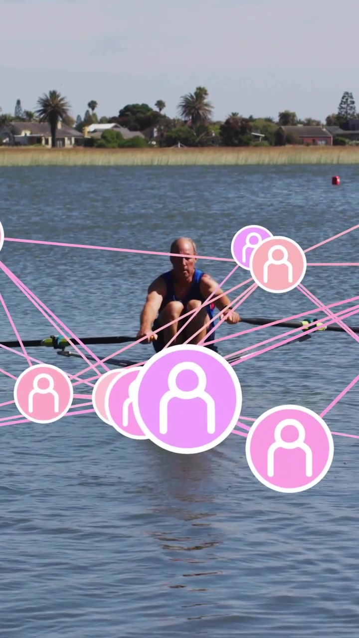 Vertical video: Male rower rowing and placing blades, causing pink overlay around boat for sports