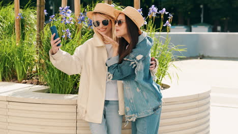 two women taking a selfie in a park