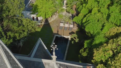 a pointed roofed house is depicted with a pool in the garden nearby