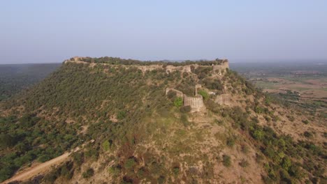 aerial drone shot of an ancient fort on top of a hill in gwalior, india