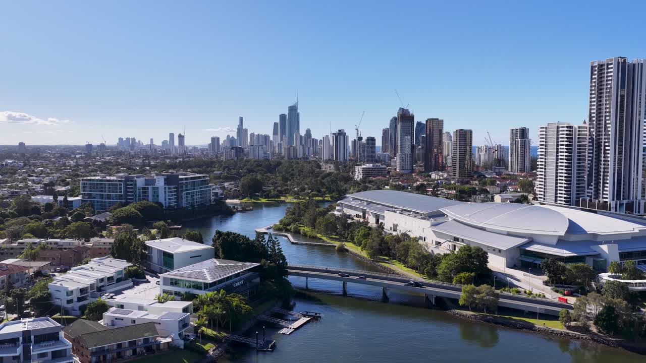 Drone footage captures the Gold Coast's skyline and waterfront, showcasing modern architecture and scenic waterways under clear blue skies
