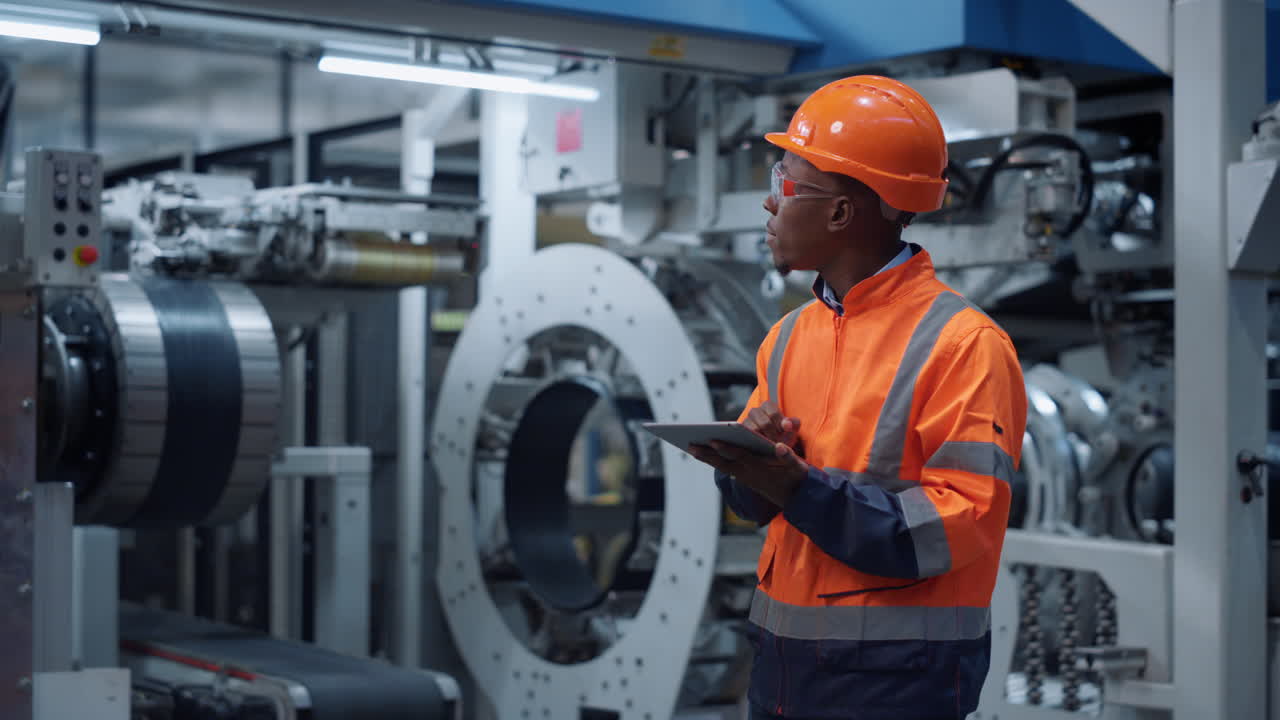 Specialist using gadget on machinery factory. Supervisor work business project