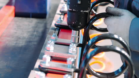 mechanic working with pneumatic wrench during process of assembly of unit