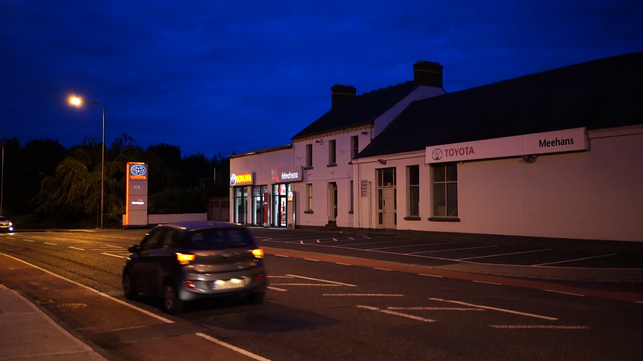 View of the road and auto parts store, cars pass by the street in Dundalk , Ireland