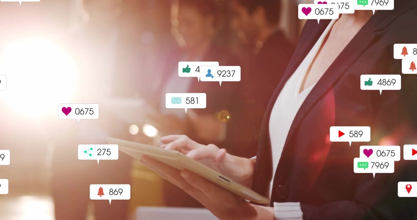 Businesswoman tapping tablet and causing icons showing social media engagement surge with team