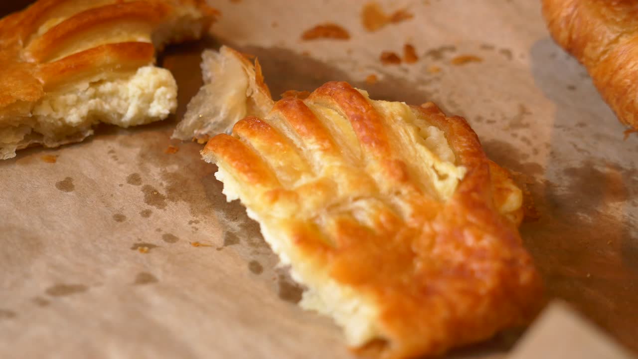 Hands breaking a creamy pastry