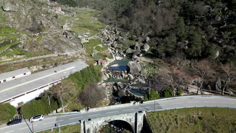 Drone-flyover-Loriga-Bridge,-Towards-Small-river-pool-surrounded-by-rocks,-Serra-da-Estrela