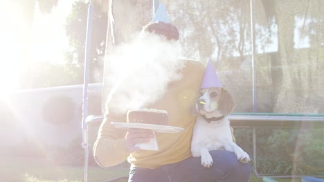 young man celebrating pet dog birthday in garden 4k 4k