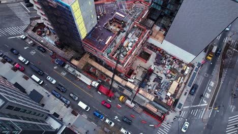 aerial overview of people working at a urban construction site in usa - high angle, orbit, drone shot