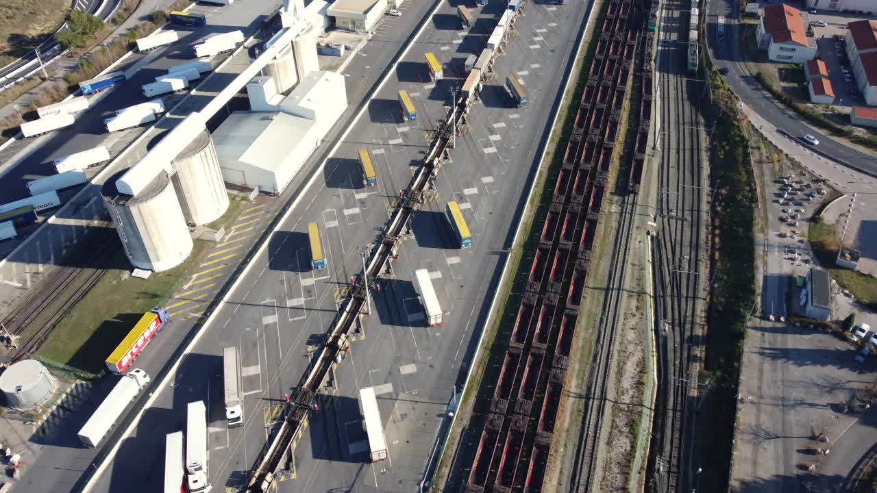 Aerial view of a logistics terminal with trains and trucks