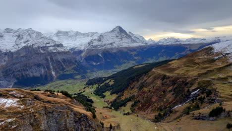 first cliff metal walk way grindelwald switzerland swiss alps snowy jungfrau junfrangu glacier lauterbrunnen mountain peaks october cloudy autumn evening landscape sunset valley waterfalls pan left