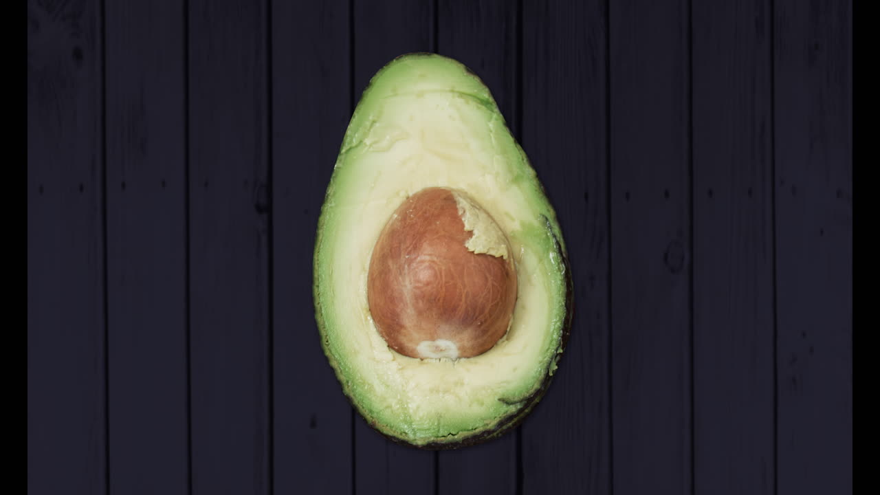 Animation of one avocado on black background