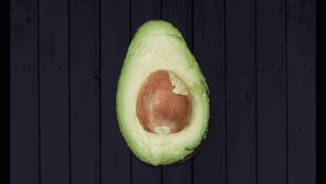 animation of one avocado on black background
