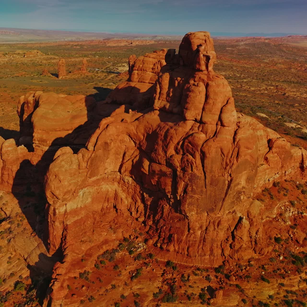 Unusual sunlit mount with rounded edges in the middle of desert. Panning footage of beautiful rock in the Utah Canyons, USA