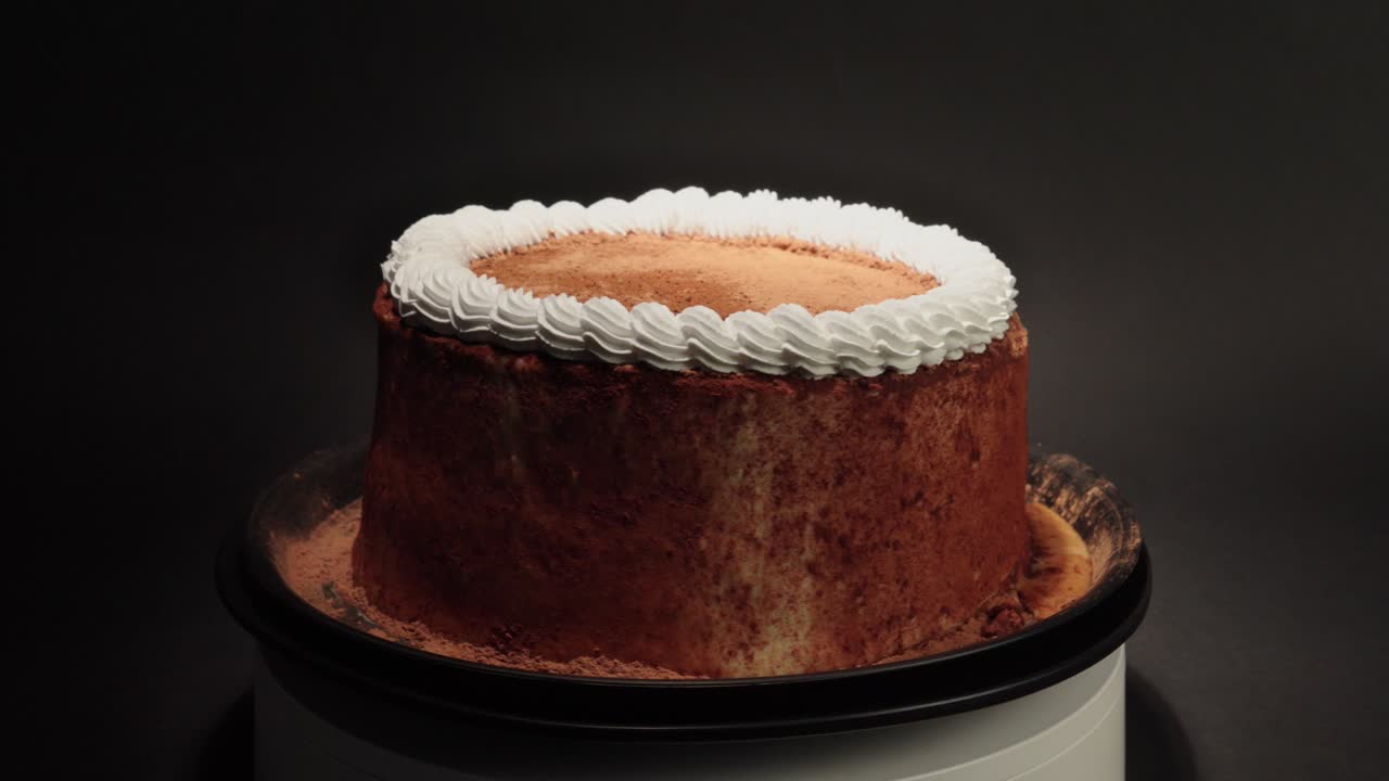 Cinnamon cake with creme in a turn table sweet tasty healthy black background loop