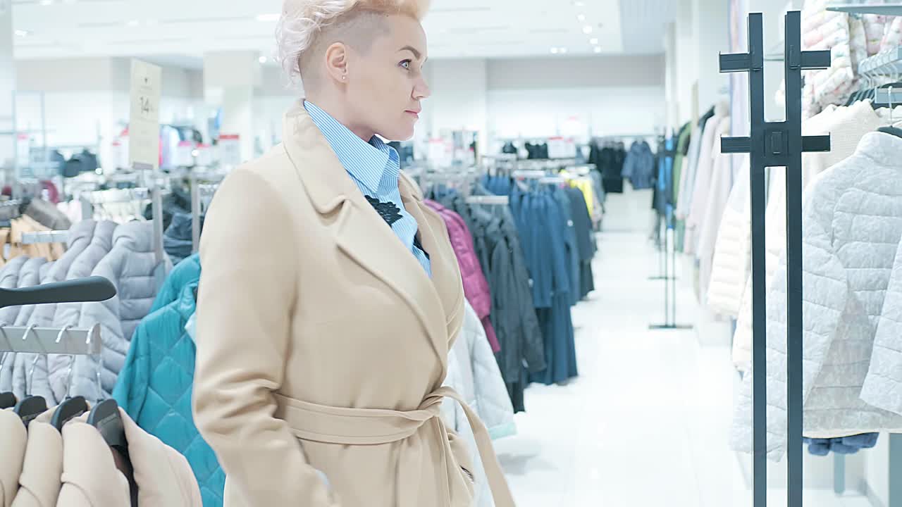 Woman Shopping for Coats in a Clothing Store