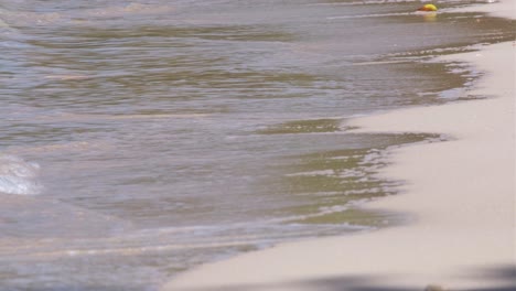 medium-close-up-of-white-sand-beach-with-ocean-gently-lapping-on-sand