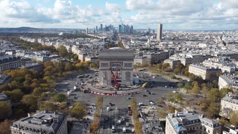 drone view of the arc de triomphe with skyscrapers in the background.