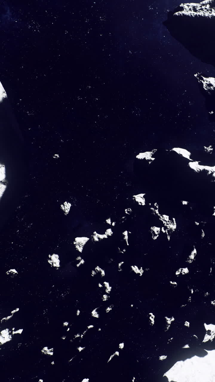 Asteroideja ja pimeää avaruutta näkyvissä taivaankappaleiden pinnan yläpuolella.