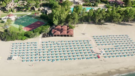 Aerial-view-of-beautiful-sea-and-beach-with-parasol-at-sunny-day,-Simeri-Mare,-Calabria,-Southern-Italy