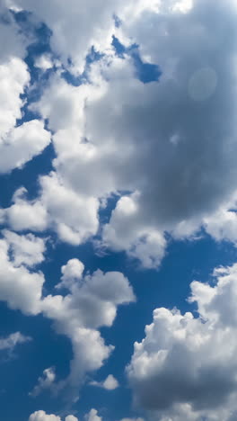 multiple cotton clouds quickly transforming in the atmosphere. soft cloudscape formation on sunny daytime. timelapse. vertical video