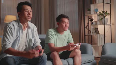 young asian friends with joystick playing video games and disappointed