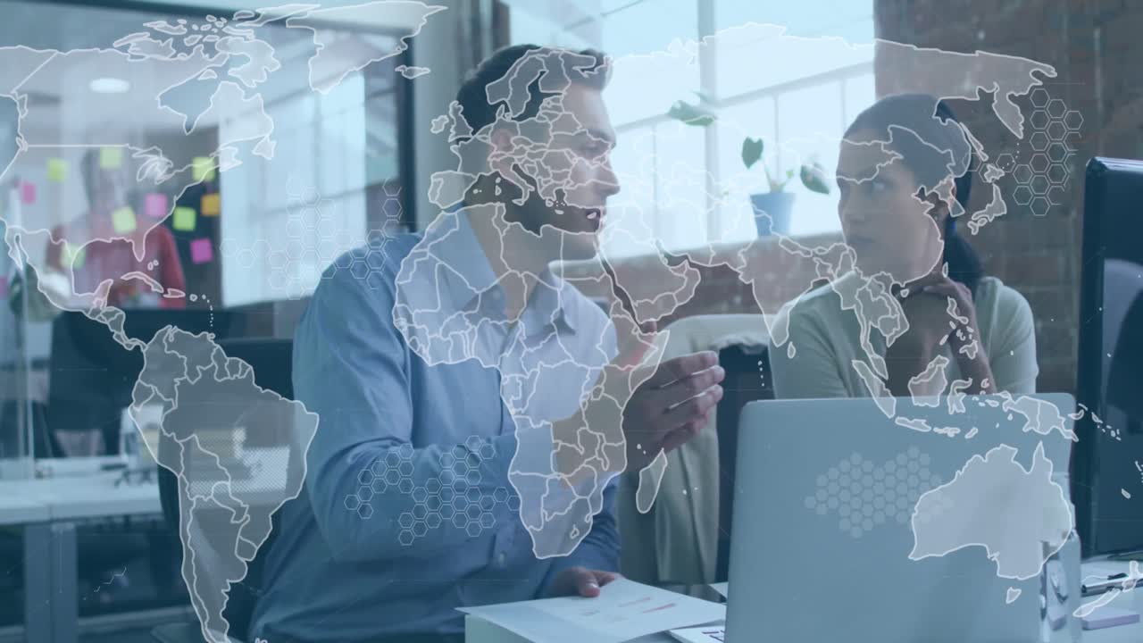 Animation of data processing and world map over diverse man and woman discussing at office
