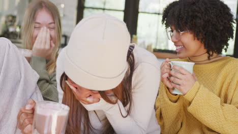 happy diverse teenager girls friends drinking coffee and laughing at home, slow motion