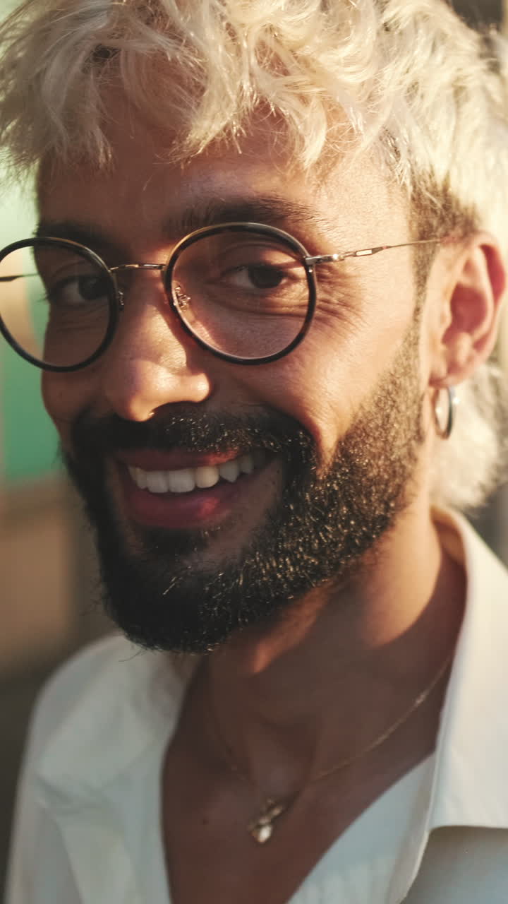 Close-up Portrait of a Smiling Man with Bleached Hair and Beard