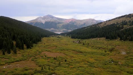 4k aerial drone footage over field meadow at mayflower gulch in rocky mountains colorado summit county near leadville and copper mountain