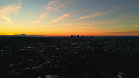 Aerial-View-of-Twilight-Above-Los-Angeles-California-USA,-Yellow-Skyline-and-City-Buildings