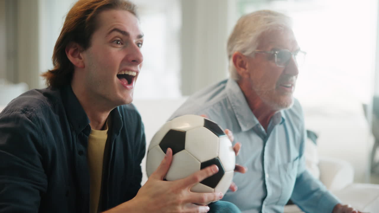 Family watching soccer game at home
