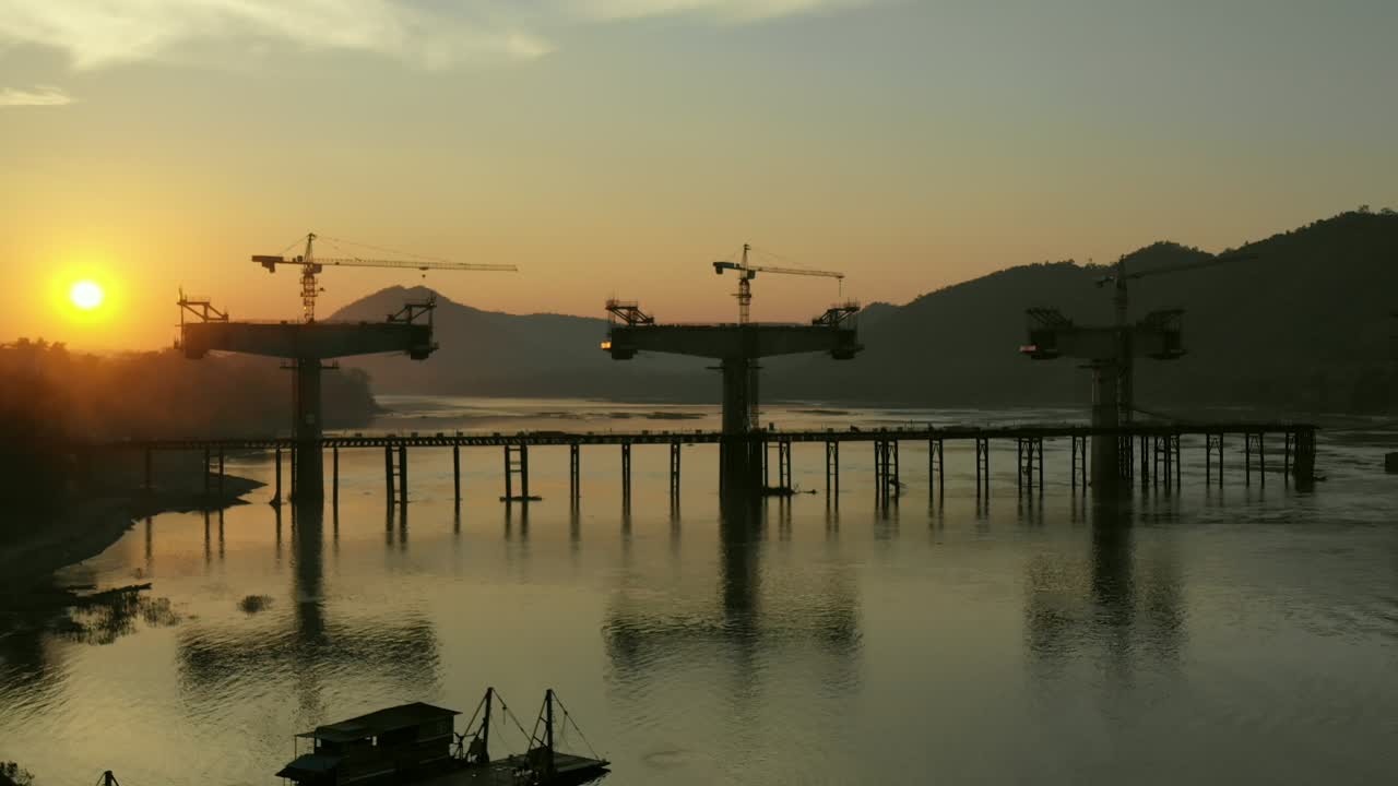 Bridge Construction Over River at Sunset